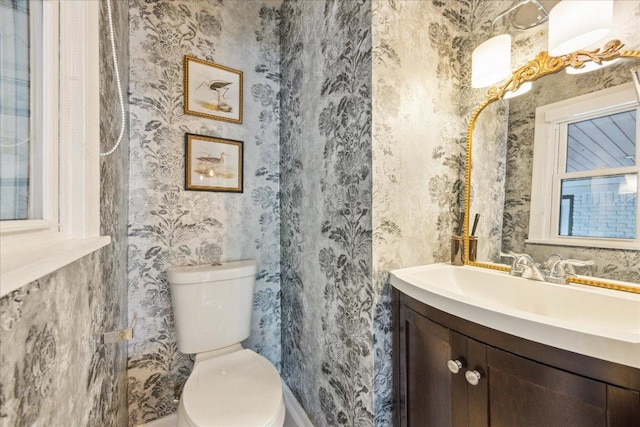 5808 Marilyn Dr, Austin, TX 78757 - bathroom featuring vanity, toilet, wallpapered walls, and baseboards