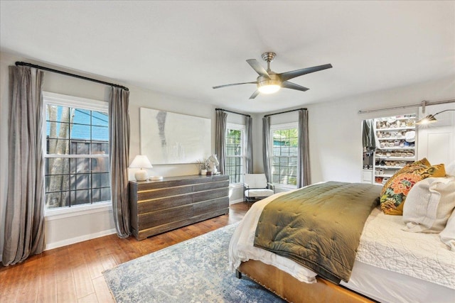 5808 Marilyn Dr, Austin, TX 78757 - bedroom featuring baseboards, wood finished floors, and a ceiling fan