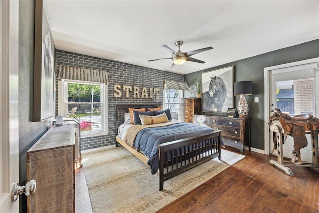 5808 Marilyn Dr, Austin, TX 78757 - bedroom featuring multiple windows, wood-type flooring, a ceiling fan, and brick wall