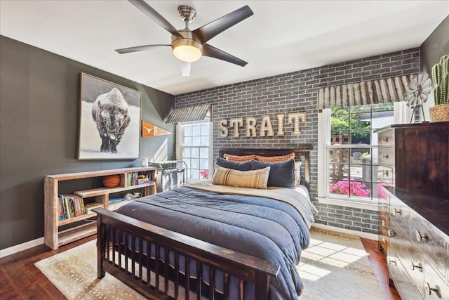 5808 Marilyn Dr, Austin, TX 78757 - bedroom with wood finished floors, brick wall, and a ceiling fan