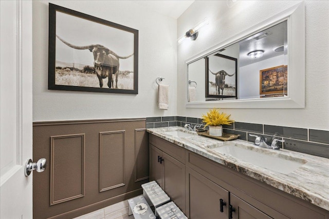 5808 Marilyn Dr, Austin, TX 78757 - bathroom with double vanity and wainscoting