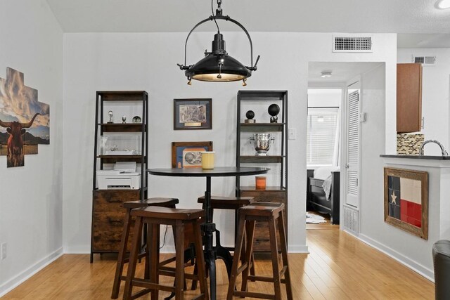 3601 Menchaca Rd Unit 215, Austin, TX 78704 - dining room featuring light wood-type flooring and baseboards