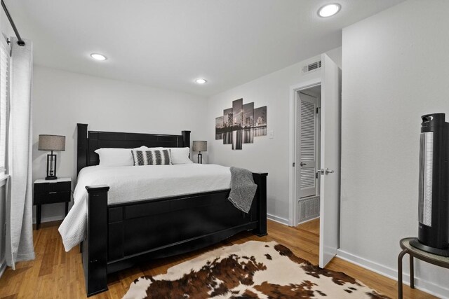 3601 Menchaca Rd Unit 215, Austin, TX 78704 - bedroom featuring light wood finished floors, baseboards, and recessed lighting