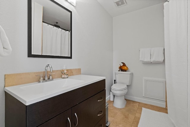 3601 Menchaca Rd Unit 215, Austin, TX 78704 - full bathroom featuring vanity, toilet, tile patterned flooring, and baseboards
