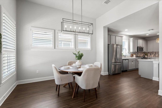 8103 Chrysler Bnd, Austin, TX 78744 - dining space featuring dark wood-type flooring and baseboards