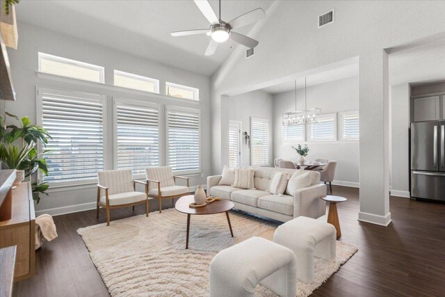 8103 Chrysler Bnd, Austin, TX 78744 - living area featuring a chandelier, ceiling fan, baseboards, high vaulted ceiling, and dark wood-style floors