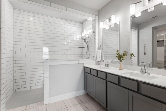 8103 Chrysler Bnd, Austin, TX 78744 - bathroom featuring a walk in shower, double vanity, tile patterned flooring, and a closet