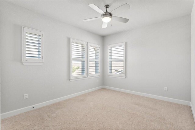 8103 Chrysler Bnd, Austin, TX 78744 - unfurnished room featuring light carpet, a ceiling fan, and baseboards