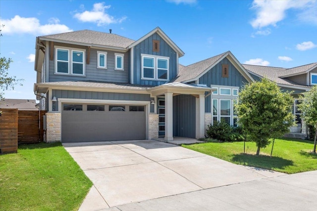 8103 Chrysler Bnd, Austin, TX 78744 - view of front facade featuring board and batten siding, driveway, a shingled roof, a garage, and stone siding