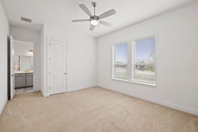 269 Call Dr, Austin, TX 78737 - unfurnished bedroom with light carpet, ensuite bath, and a ceiling fan