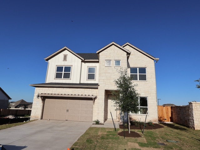 1200 Snowdrop Dr, Georgetown, TX 78628 - view of front facade with a garage, concrete driveway, board and batten siding, and stone siding