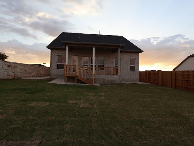 1200 Snowdrop Dr, Georgetown, TX 78628 - rear view of house with a fenced backyard and brick siding