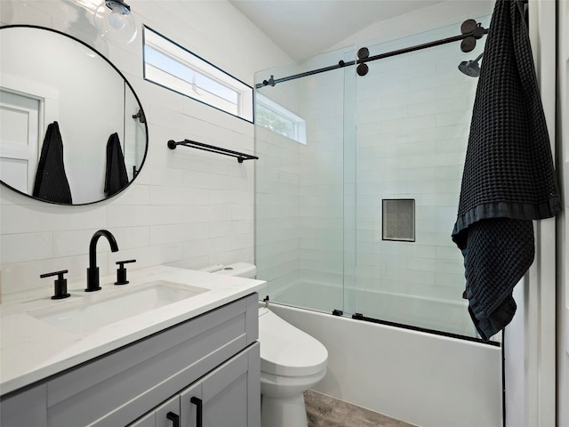 2910 Garwood St Unit A, Austin, TX 78702 - full bathroom with toilet, bath / shower combo with glass door, vanity, decorative backsplash, and wood finished floors