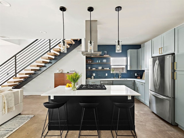 2910 Garwood St Unit A, Austin, TX 78702 - kitchen with stainless steel appliances, finished concrete floors, light countertops, a kitchen island, and a breakfast bar area