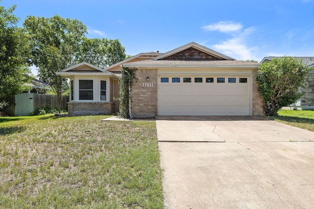 11611 Prairie Hen Ln, Austin, TX 78758 - ranch-style house with brick siding, concrete driveway, and an attached garage