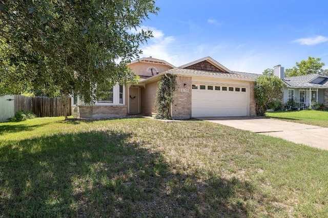 11611 Prairie Hen Ln, Austin, TX 78758 - view of front of home featuring brick siding, an attached garage, and concrete driveway
