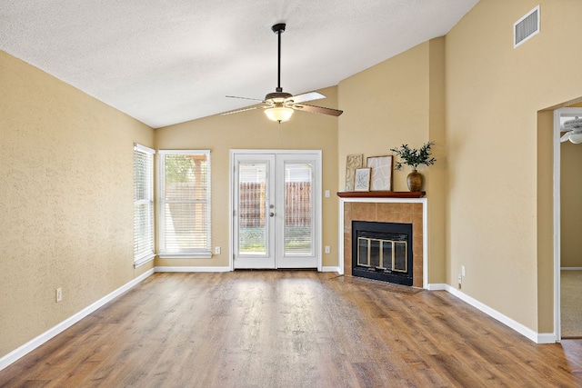 11611 Prairie Hen Ln, Austin, TX 78758 - unfurnished living room with a ceiling fan, lofted ceiling, wood finished floors, and french doors