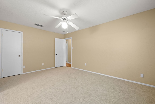 11611 Prairie Hen Ln, Austin, TX 78758 - unfurnished bedroom featuring carpet, baseboards, and ceiling fan