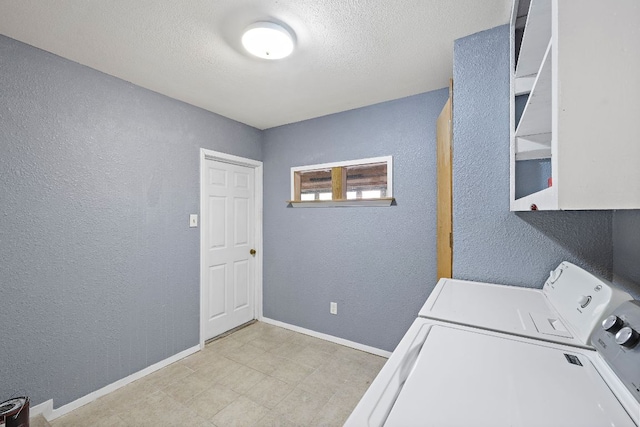 11611 Prairie Hen Ln, Austin, TX 78758 - laundry area featuring washing machine and clothes dryer, a textured wall, baseboards, and a textured ceiling