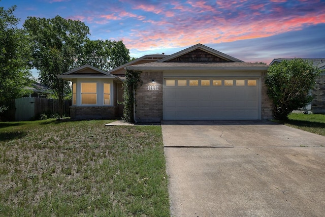 11611 Prairie Hen Ln, Austin, TX 78758 - single story home with brick siding, driveway, and a garage