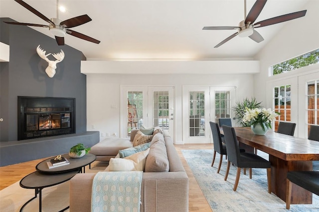 2103 W 10th St, Austin, TX 78703 - living room with a ceiling fan, french doors, light wood-style floors, a fireplace, and high vaulted ceiling