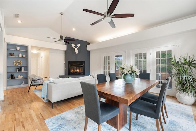 2103 W 10th St, Austin, TX 78703 - dining area with a ceiling fan, lofted ceiling, built in features, light wood finished floors, and a glass covered fireplace