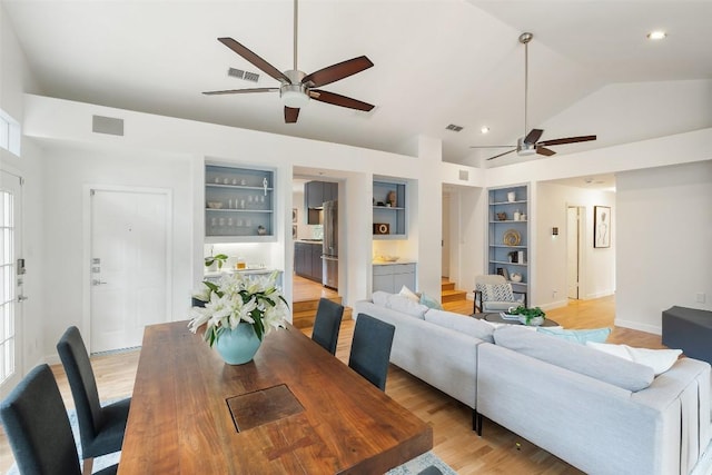 2103 W 10th St, Austin, TX 78703 - living area featuring a ceiling fan, built in features, vaulted ceiling, stairway, and light wood finished floors