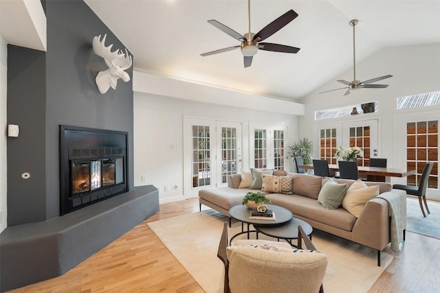 2103 W 10th St, Austin, TX 78703 - living area featuring french doors, a ceiling fan, light wood-style flooring, plenty of natural light, and high vaulted ceiling