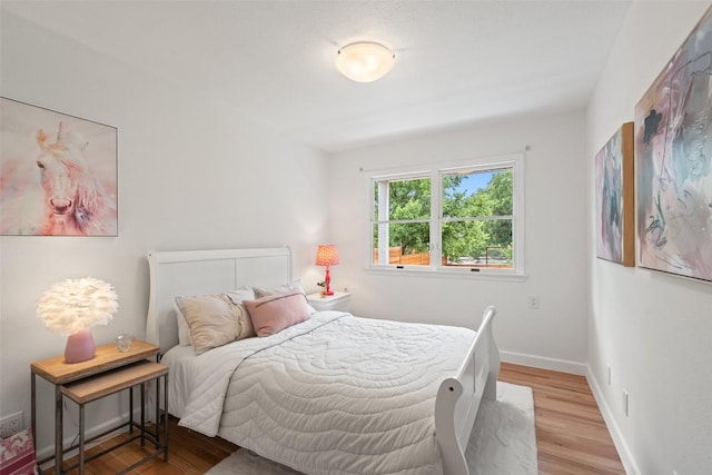 2103 W 10th St, Austin, TX 78703 - bedroom featuring wood finished floors and baseboards