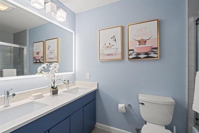 2103 W 10th St, Austin, TX 78703 - bathroom featuring double vanity, a shower with shower door, toilet, and baseboards
