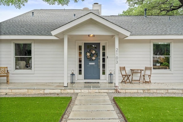 2103 W 10th St, Austin, TX 78703 - doorway to property featuring a shingled roof, a porch, and a chimney