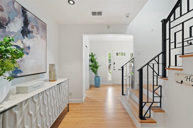 2103 W 10th St, Austin, TX 78703 - foyer featuring light wood-style flooring, stairway, and baseboards