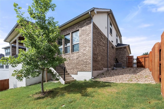 6408 Empresa Dr, Austin, TX 78738 - view of side of home with brick siding, stucco siding, cooling unit, and stairs