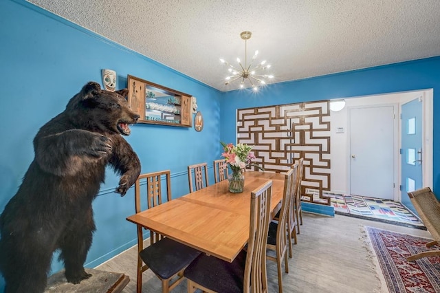 3304 Whitepine Dr, Austin, TX 78757 - dining room with a chandelier, a textured ceiling, and wood finished floors