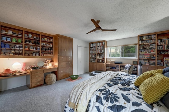 3304 Whitepine Dr, Austin, TX 78757 - carpeted bedroom featuring built in study area, a textured ceiling, a ceiling fan, and a closet