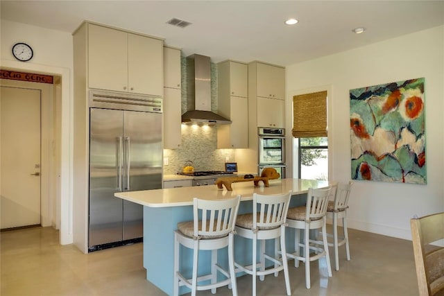 281 Kendall Jackson, Comfort, TX 78013 - kitchen with stainless steel appliances, wall chimney range hood, tasteful backsplash, light countertops, and concrete flooring
