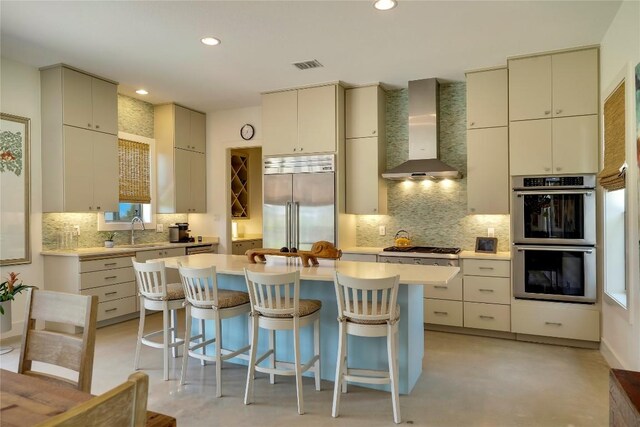 281 Kendall Jackson, Comfort, TX 78013 - kitchen with wall chimney range hood, appliances with stainless steel finishes, decorative backsplash, a sink, and recessed lighting