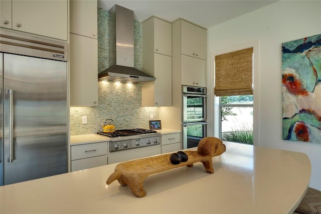 281 Kendall Jackson, Comfort, TX 78013 - kitchen featuring appliances with stainless steel finishes, wall chimney range hood, decorative backsplash, and light countertops