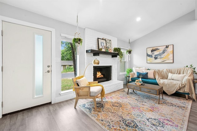 1804 Matthews Ln Unit B, Austin, TX 78745 - living room with wood finished floors, plenty of natural light, lofted ceiling, a brick fireplace, and recessed lighting