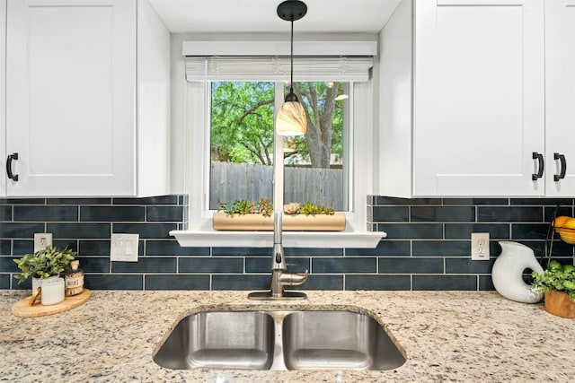 1804 Matthews Ln Unit B, Austin, TX 78745 - kitchen view of white cabinets, decorative backsplash, and light stone countertops