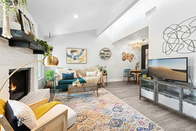 1804 Matthews Ln Unit B, Austin, TX 78745 - living room with lofted ceiling, wood finished floors, a brick fireplace, and recessed lighting
