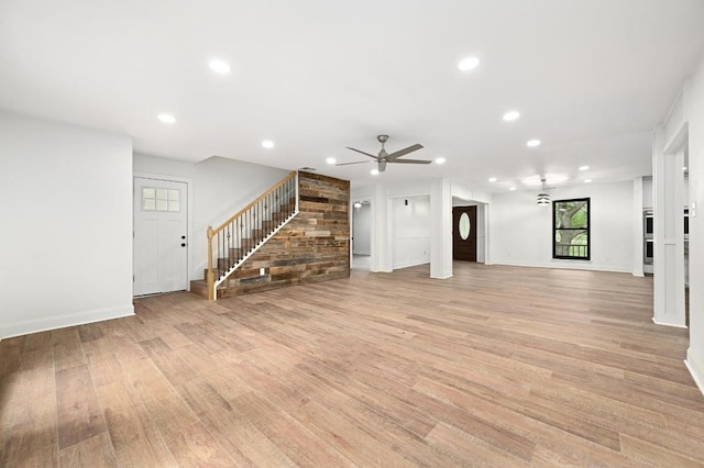 322 Mesa Oaks, Leander, TX 78641 - unfurnished living room with stairway, light wood-type flooring, ceiling fan, recessed lighting, and baseboards