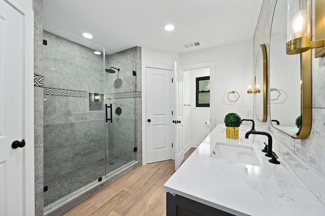 322 Mesa Oaks, Leander, TX 78641 - bathroom featuring vanity, wood finished floors, a stall shower, and recessed lighting
