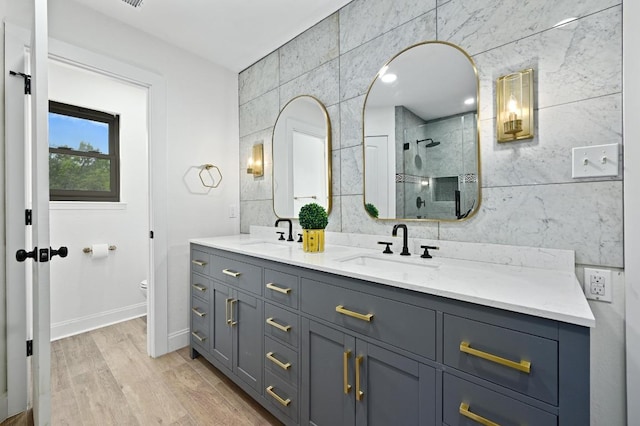 322 Mesa Oaks, Leander, TX 78641 - full bath featuring tile walls, double vanity, a shower stall, toilet, and wood finished floors