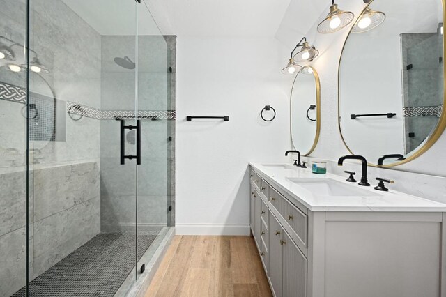 322 Mesa Oaks, Leander, TX 78641 - full bathroom with double vanity, wood finished floors, a stall shower, and baseboards