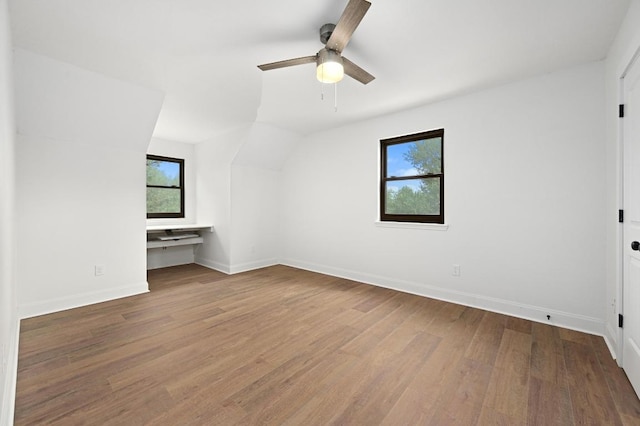 322 Mesa Oaks, Leander, TX 78641 - unfurnished bedroom featuring wood finished floors, baseboards, vaulted ceiling, and ceiling fan