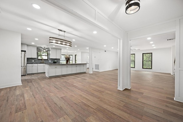 322 Mesa Oaks, Leander, TX 78641 - kitchen featuring open floor plan, freestanding refrigerator, recessed lighting, healthy amount of natural light, and light wood-style floors