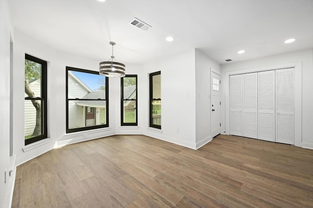 322 Mesa Oaks, Leander, TX 78641 - unfurnished dining area featuring plenty of natural light, wood finished floors, a chandelier, recessed lighting, and baseboards