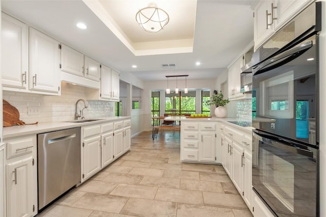 9803 Talleyran Dr, Austin, TX 78750 - kitchen featuring stainless steel dishwasher, a sink, tasteful backsplash, light countertops, and white cabinets