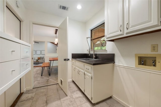 9803 Talleyran Dr, Austin, TX 78750 - kitchen with white cabinetry and wainscoting